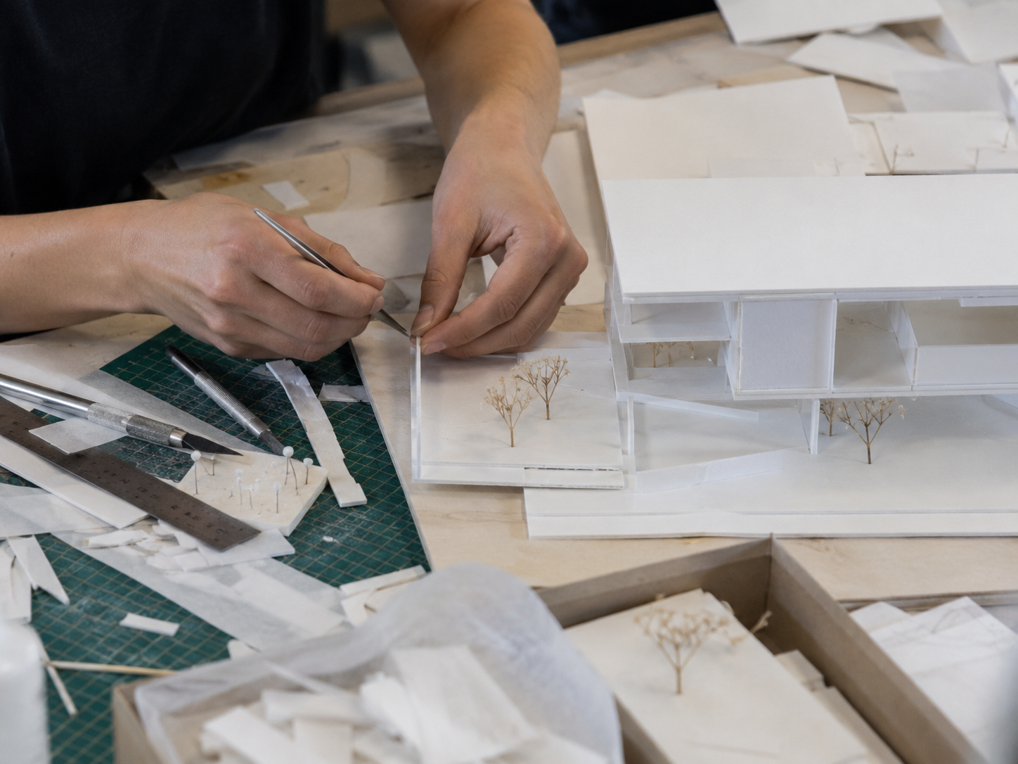 Architecture student working on a detailed physical model